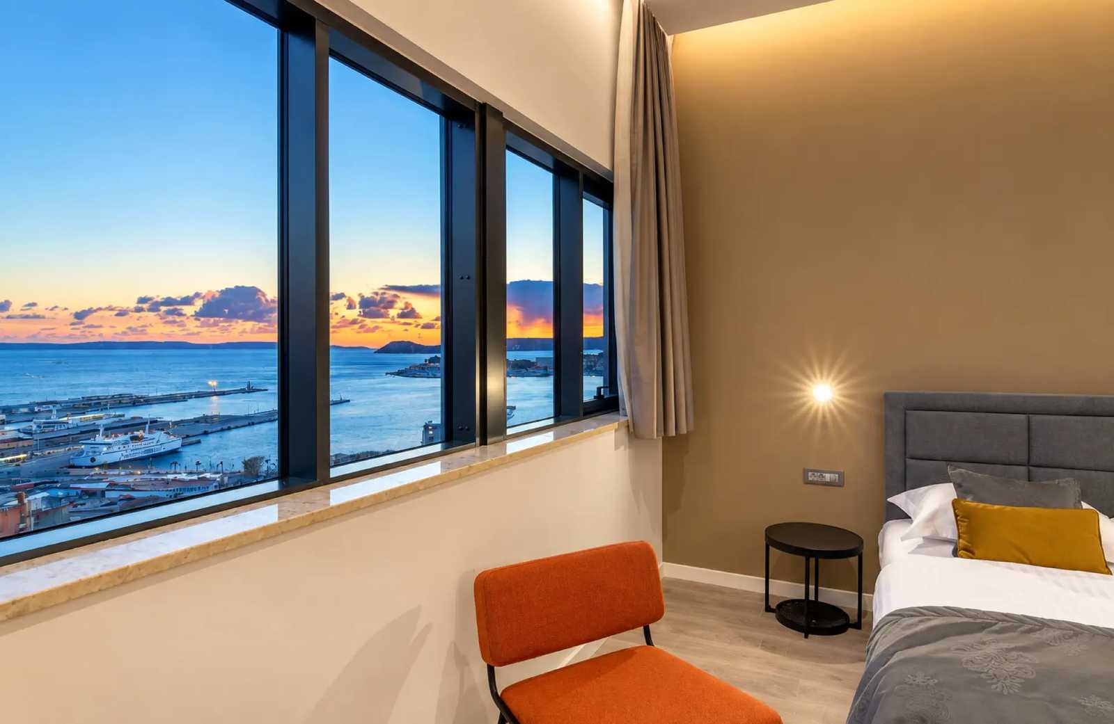 Window seat in a guest room overlooking Split harbour at dusk